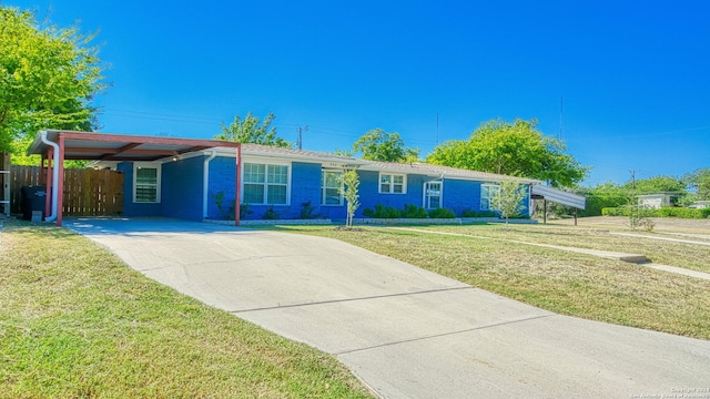 ranch-style house featuring a front yard and a carport