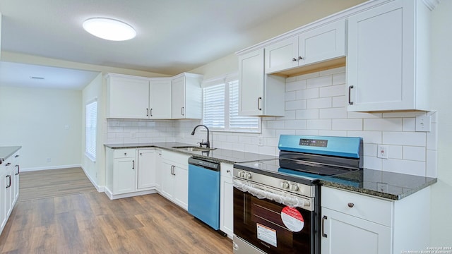 kitchen featuring dark hardwood / wood-style floors, appliances with stainless steel finishes, sink, and white cabinetry