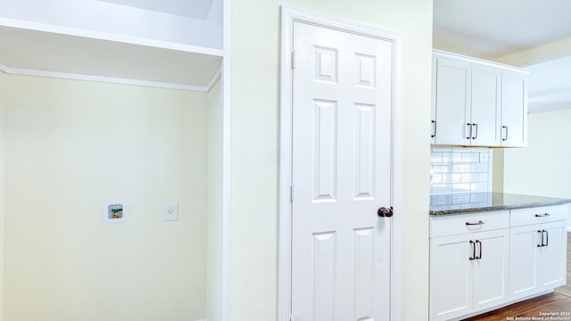 washroom featuring hookup for a washing machine and dark hardwood / wood-style flooring