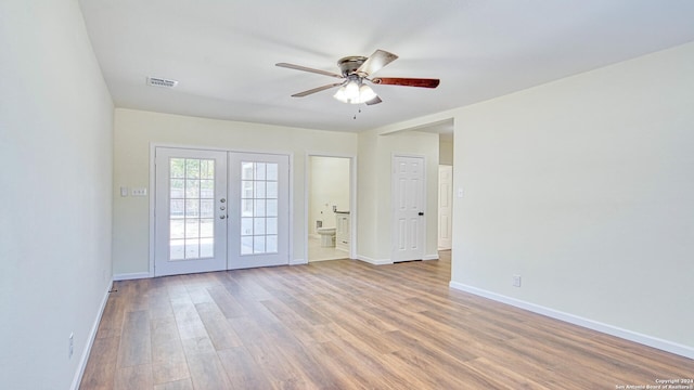 unfurnished room featuring french doors, light hardwood / wood-style floors, and ceiling fan