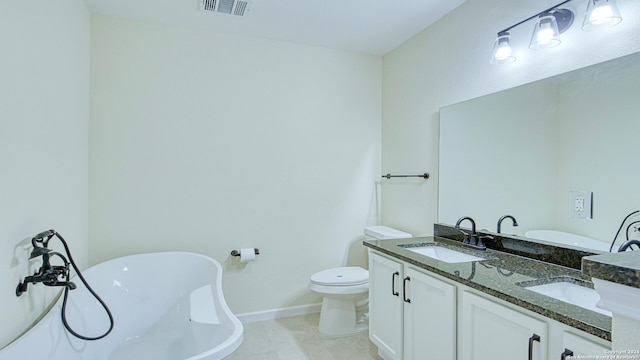 bathroom featuring a bathtub, tile patterned floors, vanity, and toilet