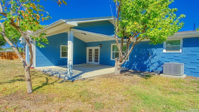 back of house with a yard, ceiling fan, central AC unit, a patio area, and french doors