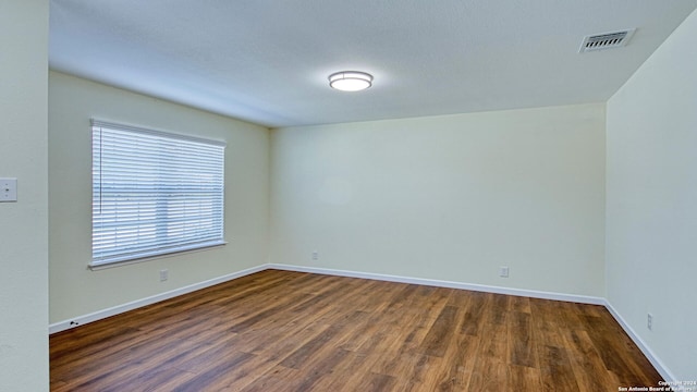 empty room with dark hardwood / wood-style floors