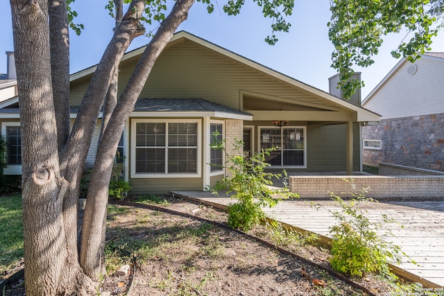 back of property featuring a wooden deck