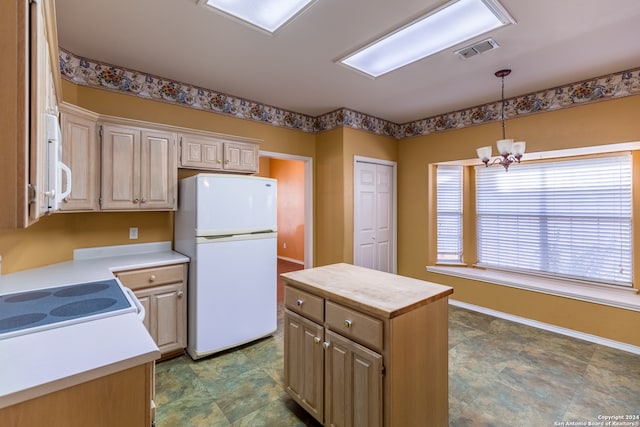 kitchen featuring a chandelier, white appliances, light brown cabinets, hanging light fixtures, and a center island