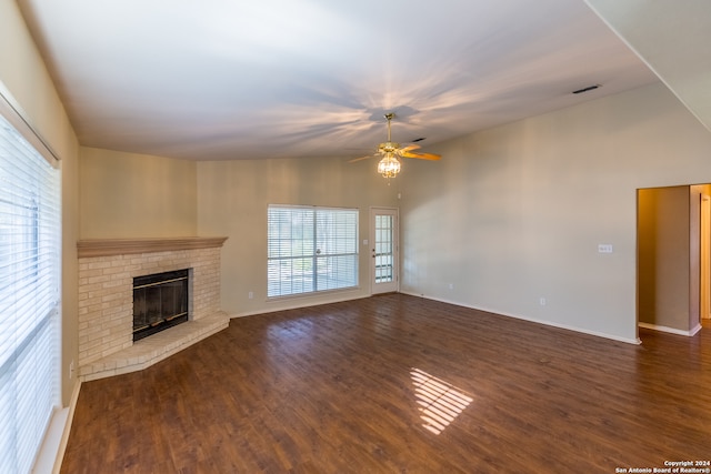 unfurnished living room featuring ceiling fan, a fireplace, and dark hardwood / wood-style flooring