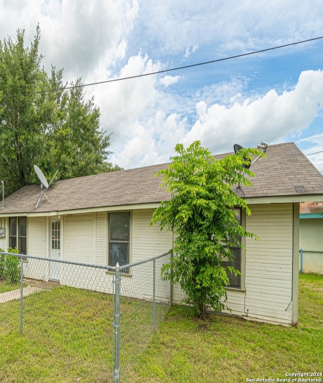 view of side of home featuring a lawn