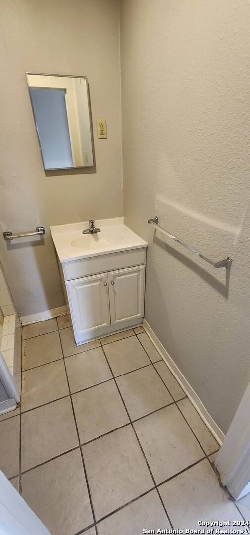 bathroom with tile patterned flooring and vanity