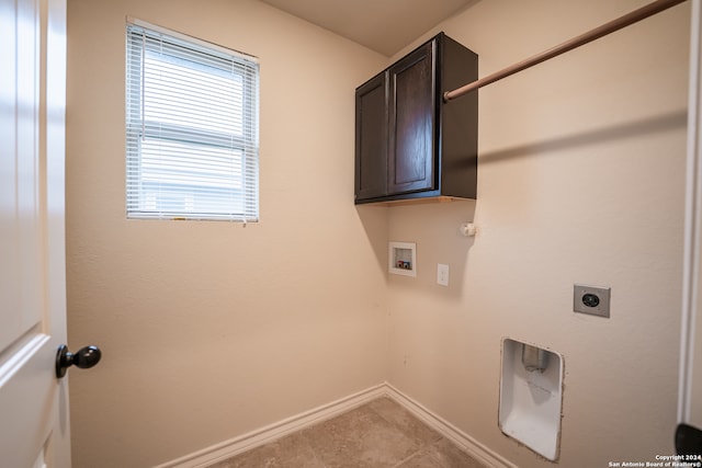 laundry area featuring hookup for an electric dryer, hookup for a washing machine, cabinets, and light tile patterned floors