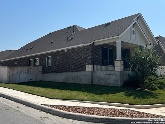 view of side of home featuring a lawn