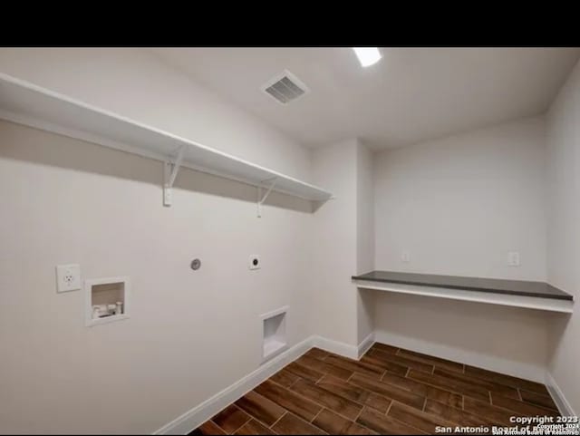 washroom featuring washer hookup, hookup for a gas dryer, dark hardwood / wood-style floors, and electric dryer hookup