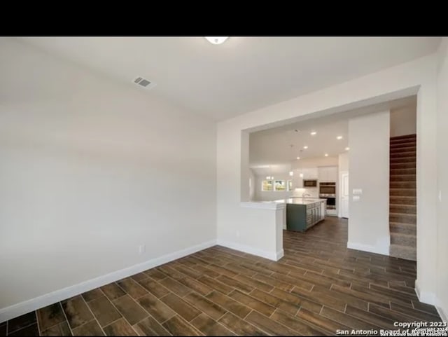 empty room with dark hardwood / wood-style flooring