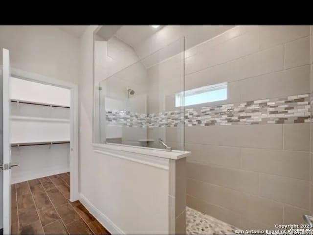 bathroom with tiled shower