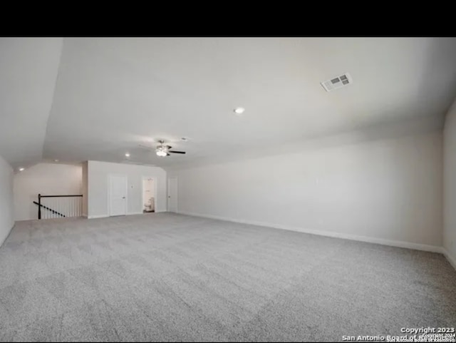 unfurnished room featuring carpet floors, lofted ceiling, and ceiling fan