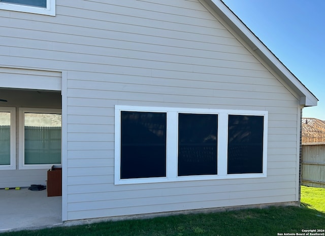 view of property exterior with a patio area