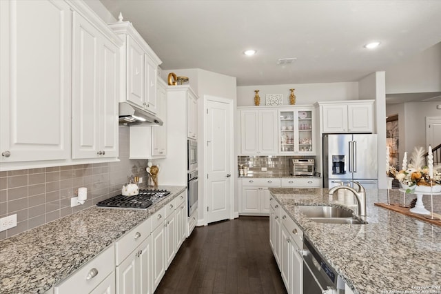 kitchen featuring dark hardwood / wood-style flooring, white cabinetry, appliances with stainless steel finishes, and sink