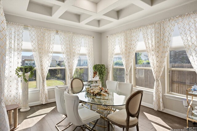 sunroom / solarium with beamed ceiling, a healthy amount of sunlight, and coffered ceiling