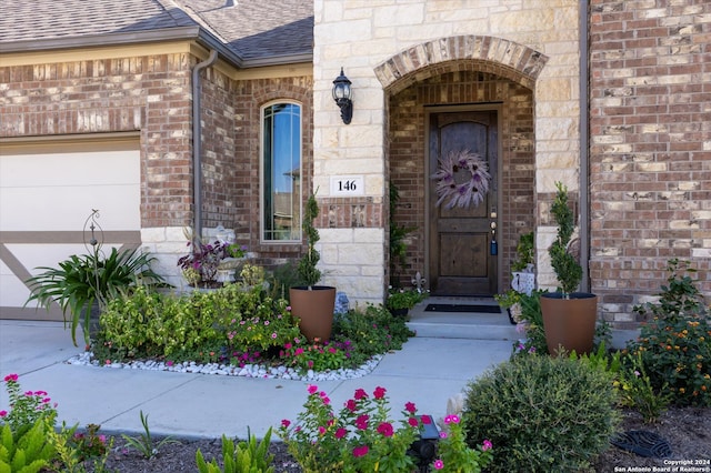 doorway to property with a garage