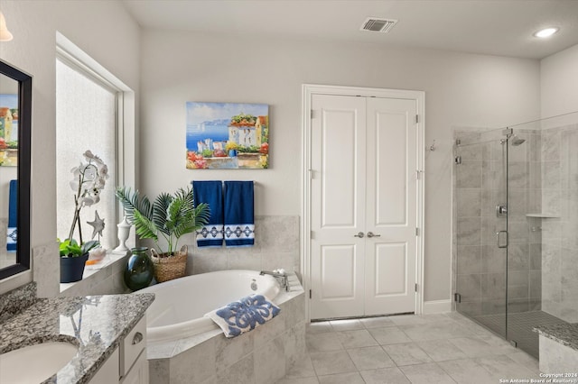 bathroom with vanity, plus walk in shower, and tile patterned flooring