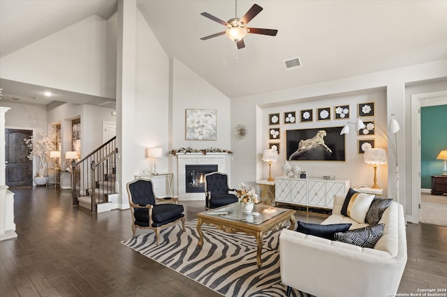 living room with ceiling fan, dark hardwood / wood-style floors, and high vaulted ceiling