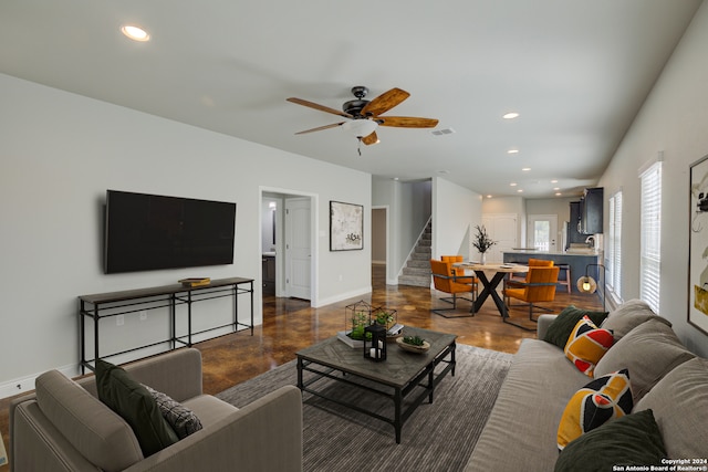 living room featuring dark wood-type flooring and ceiling fan