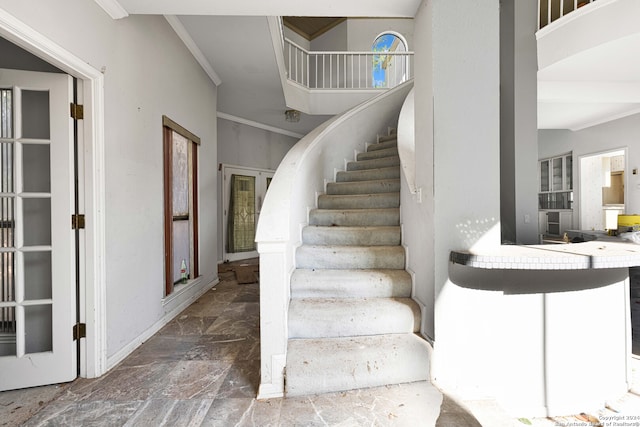 staircase featuring crown molding