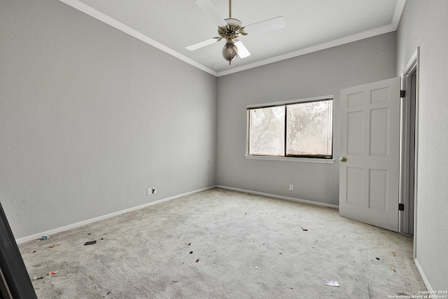 carpeted spare room with ceiling fan and crown molding