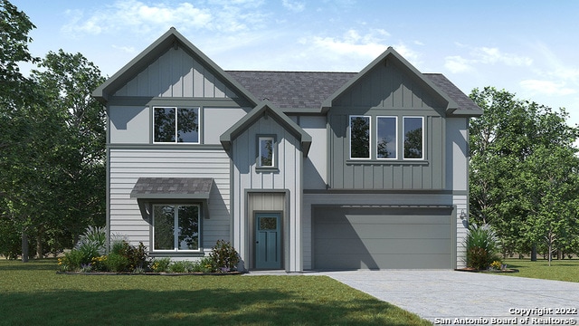 view of front of property featuring a garage and a front lawn