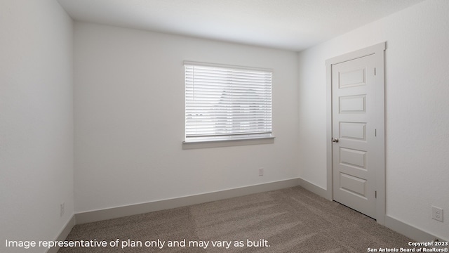 carpeted spare room with baseboards