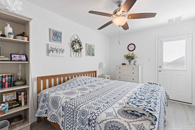 bedroom with ceiling fan and light hardwood / wood-style flooring