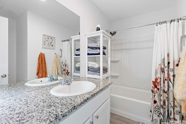 bathroom featuring hardwood / wood-style floors, shower / tub combo with curtain, and vanity