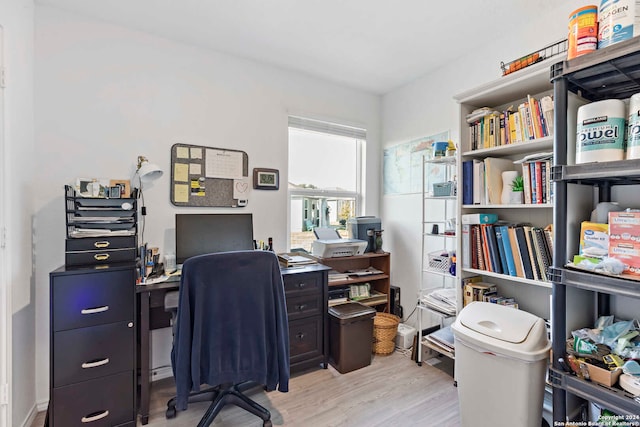 office with light wood-type flooring