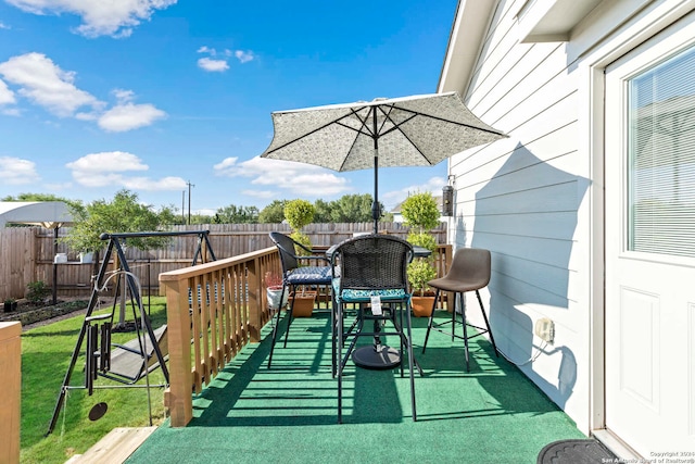 wooden deck featuring a yard