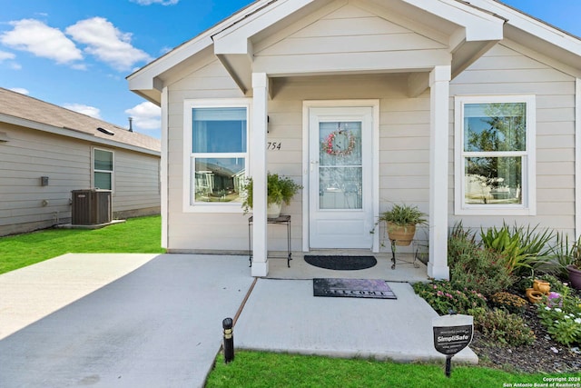 doorway to property featuring central AC unit and a patio area