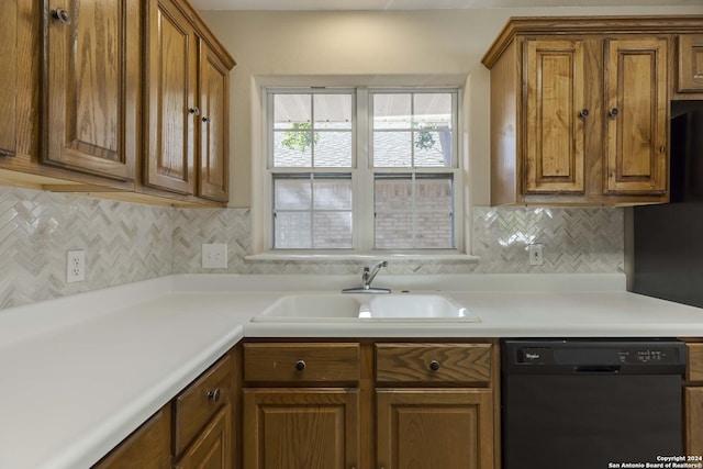 kitchen with dishwasher, brown cabinetry, tasteful backsplash, and a sink