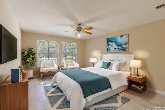 bedroom featuring baseboards, visible vents, and ceiling fan