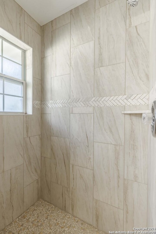 bathroom with tiled shower