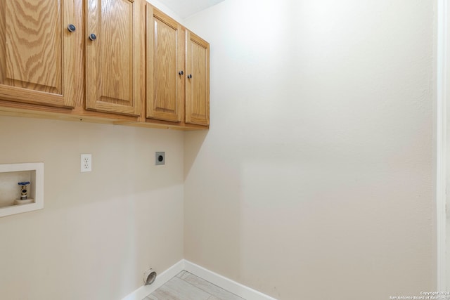 washroom featuring hookup for a washing machine, cabinets, and electric dryer hookup