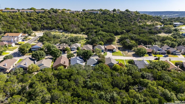 birds eye view of property with a residential view and a wooded view