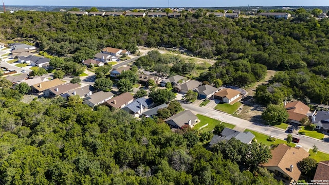 aerial view featuring a forest view and a residential view