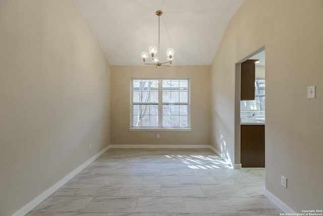 unfurnished dining area featuring lofted ceiling, marble finish floor, baseboards, and an inviting chandelier