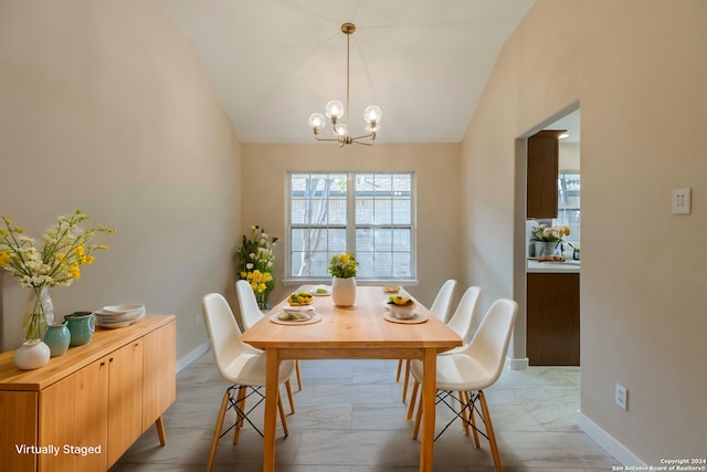 dining space with a chandelier and vaulted ceiling