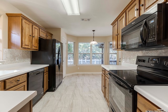 kitchen with black appliances, decorative backsplash, and decorative light fixtures