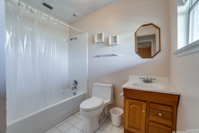 full bathroom featuring shower / tub combo with curtain, vanity, tile patterned floors, toilet, and a textured ceiling