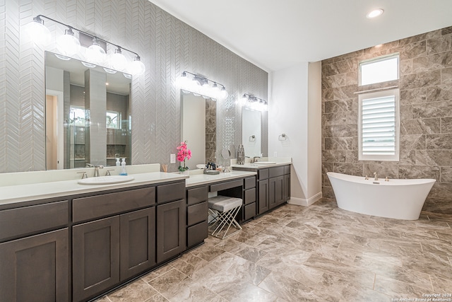 bathroom featuring tile walls, vanity, and plus walk in shower