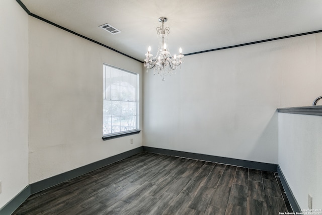 unfurnished room with a chandelier, dark hardwood / wood-style flooring, and crown molding