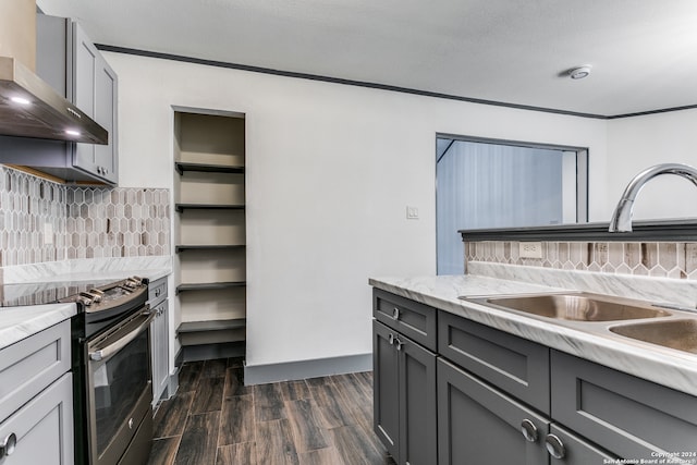 kitchen with gray cabinetry, wall chimney exhaust hood, dark wood-type flooring, sink, and stainless steel range with electric cooktop