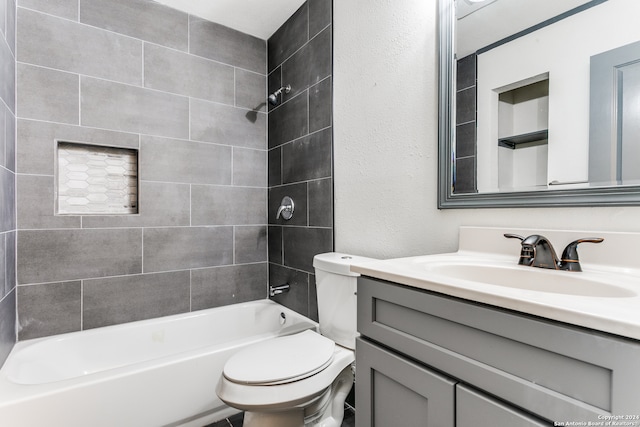 full bathroom with vanity, toilet, and tiled shower / bath