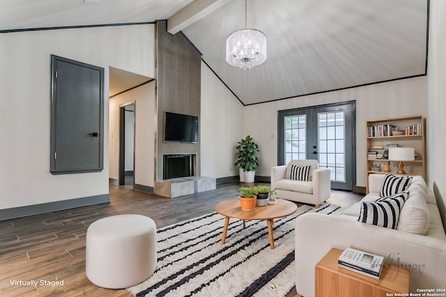 living room featuring a chandelier, hardwood / wood-style floors, beam ceiling, a fireplace, and french doors