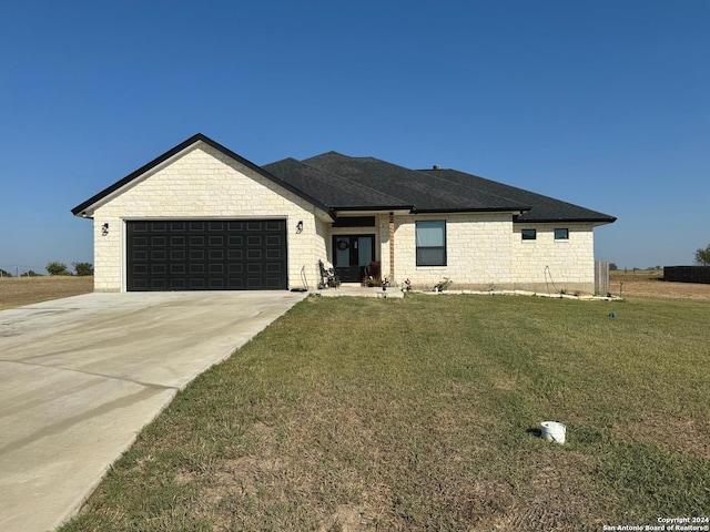 view of front of home featuring a garage and a front lawn